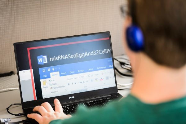 Drew Hasley uses the aid of enlarged text displayed on his laptop computer