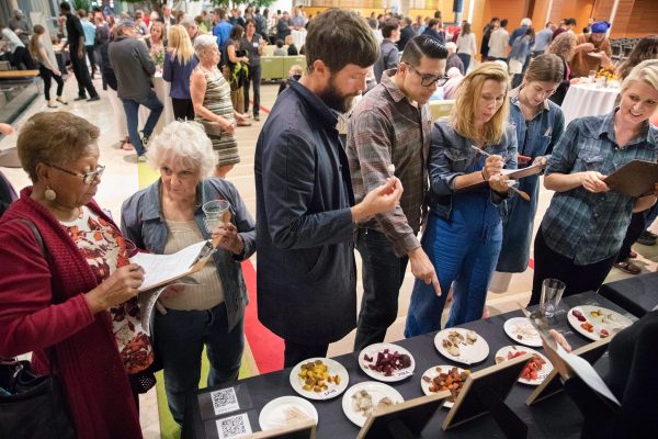People tasting new beet varieties and marking their scores on a sheet of paper.